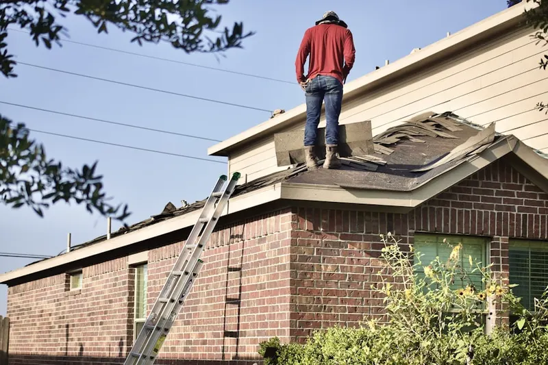 Professional roofer working on a residential roof in Freemont